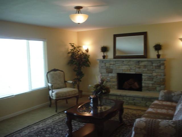 3656 West Birchfield Road Moxee, WA 98936 - Photo 14 of 31 a living room with furniture a flat screen tv and a fireplace
