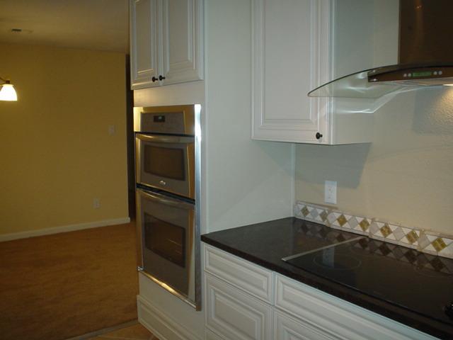 3656 West Birchfield Road Moxee, WA 98936 - Photo 6 of 31 a kitchen with a refrigerator and cabinets