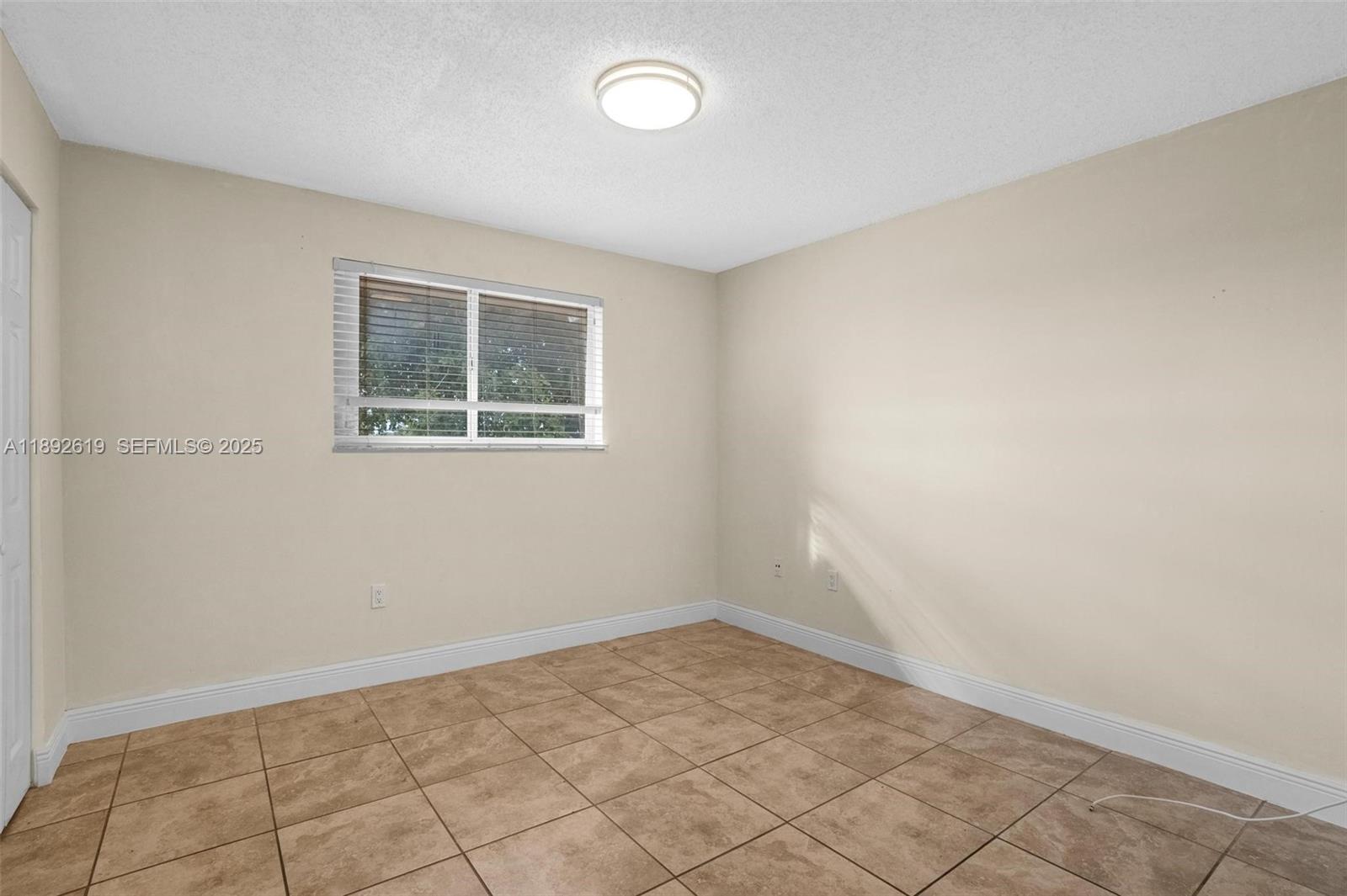 7785 West 30th Court, Unit F210 Hialeah, FL 33018 - Photo 11 of 21 an empty room with windows