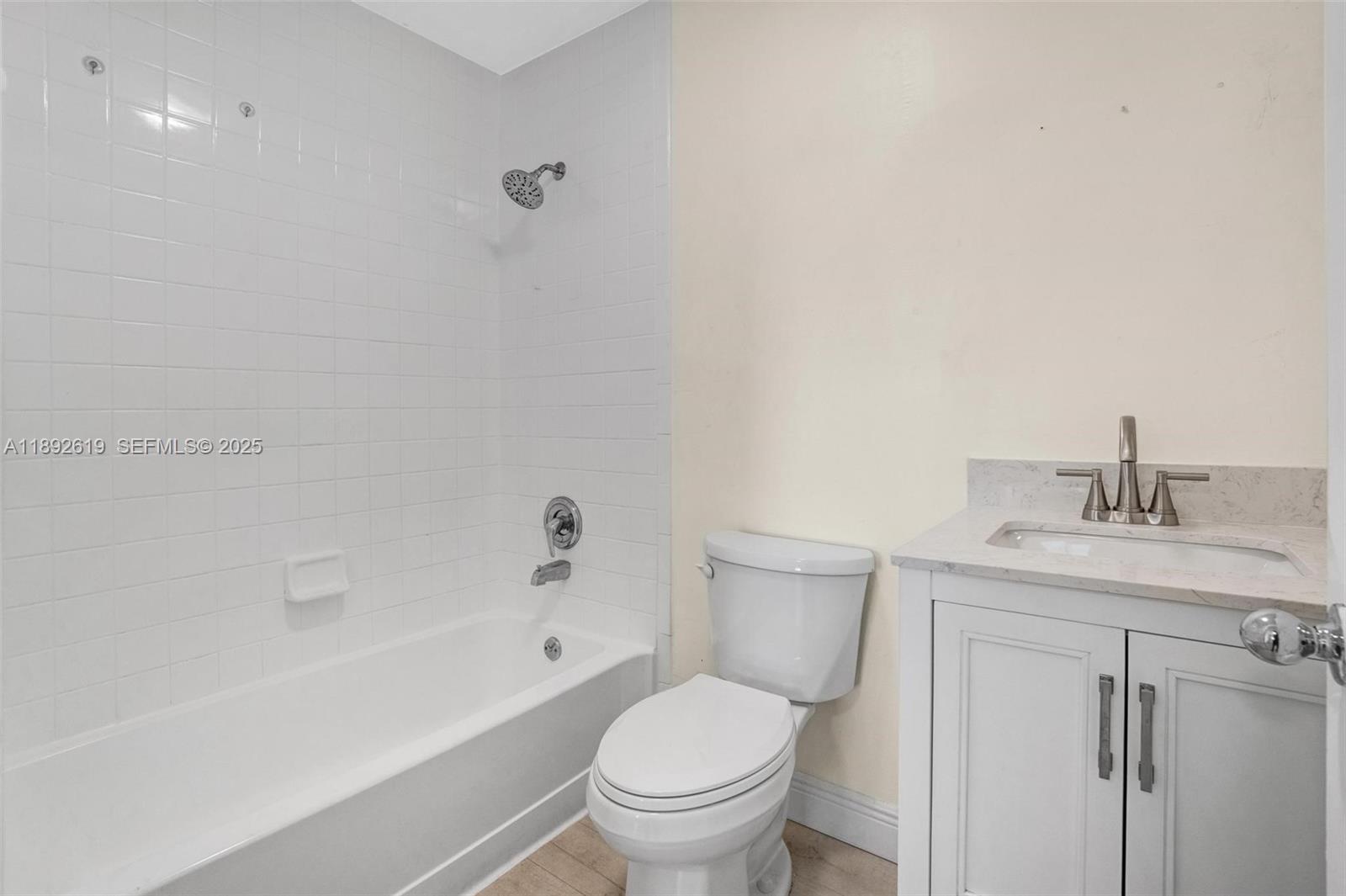 7785 West 30th Court, Unit F210 Hialeah, FL 33018 - Photo 15 of 21 a bathroom with a granite countertop toilet a sink and a bathtub