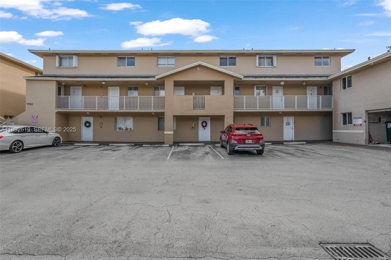 7785 West 30th Court, Unit F210 Hialeah, FL 33018 - Photo 19 of 21 a car parked in front of a building