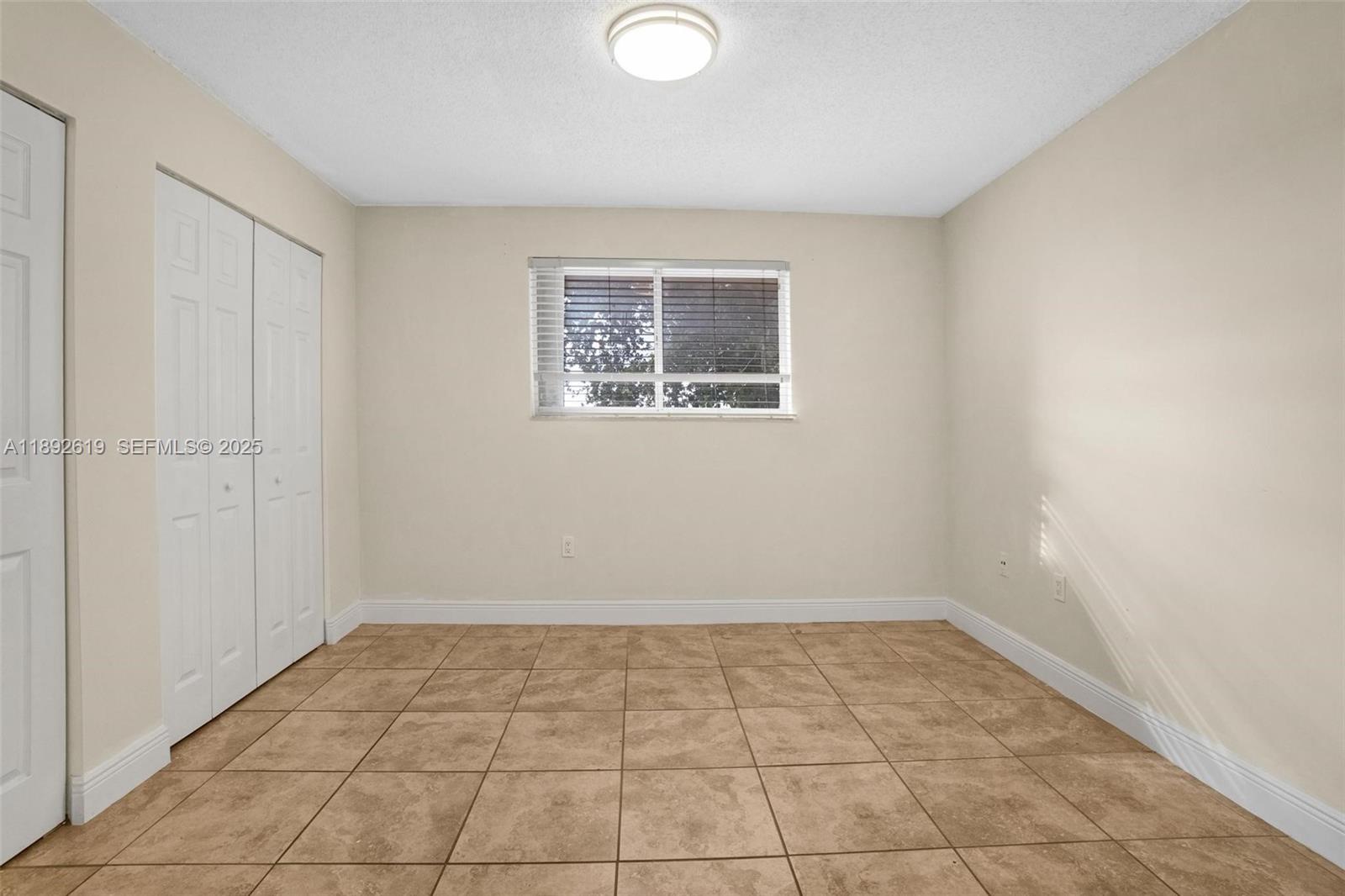 7785 West 30th Court, Unit F210 Hialeah, FL 33018 - Photo 9 of 21 a view of an empty room with a window