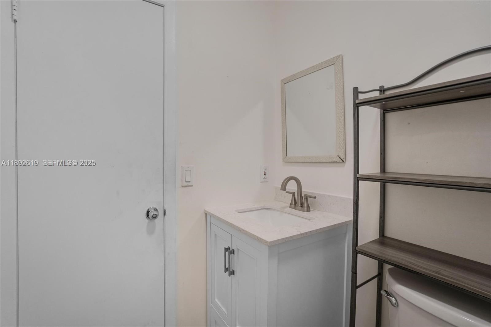 7785 West 30th Court, Unit F210 Hialeah, FL 33018 - Photo 10 of 21 a bathroom with a sink and a mirror