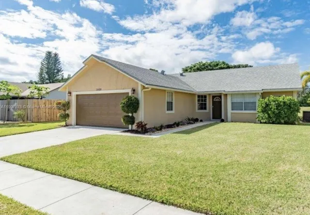 a view of a house with a yard and garage