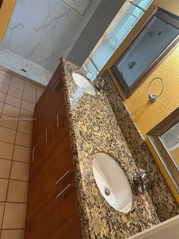 a bathroom with a sink and a shower