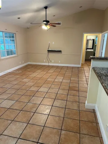 a view of a kitchen with a sink and chandelier