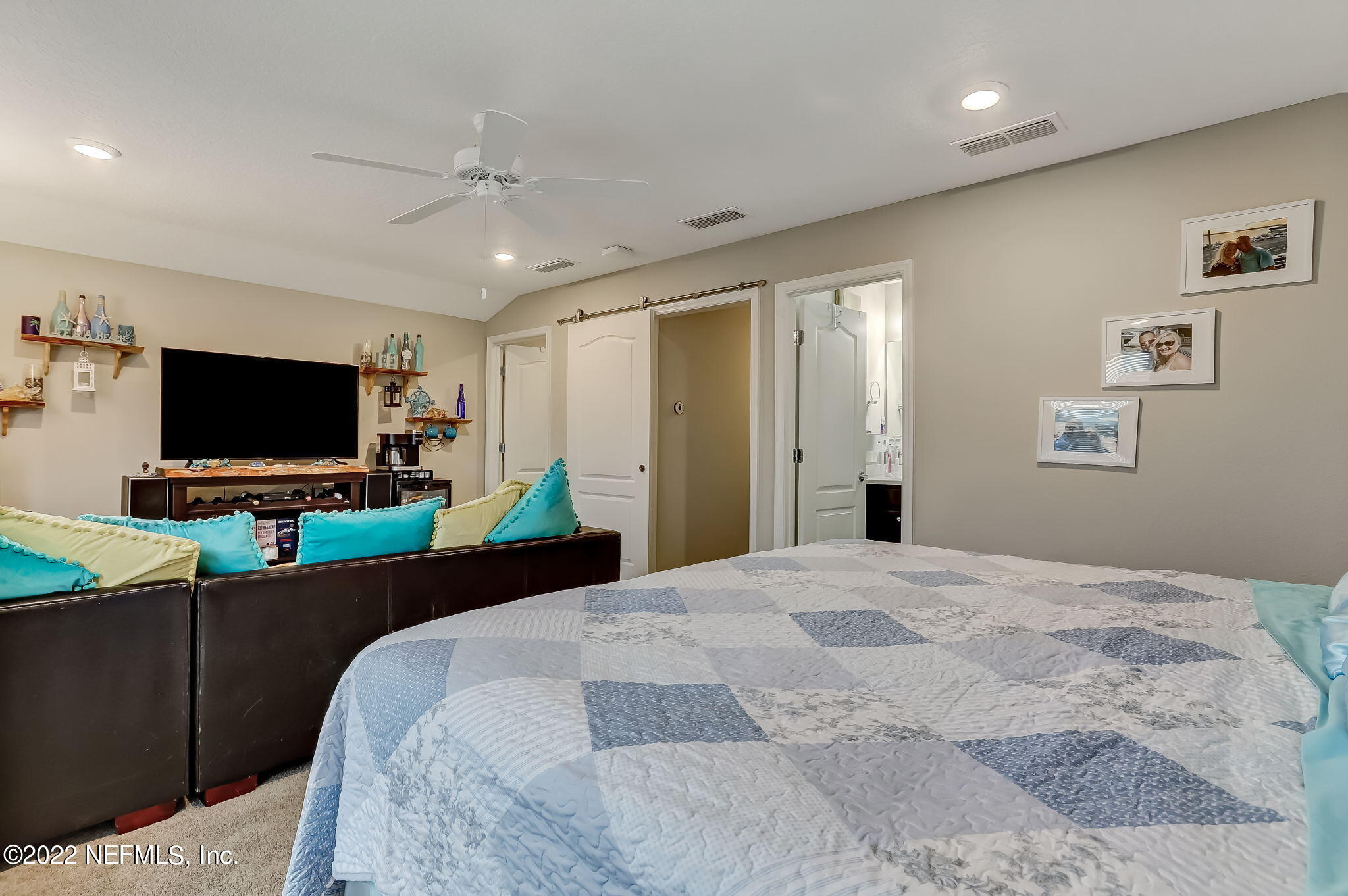 2564 Alexia Circle Jacksonville, FL 32246 - Photo 44 of 67 a bedroom with a bed and a flat screen tv