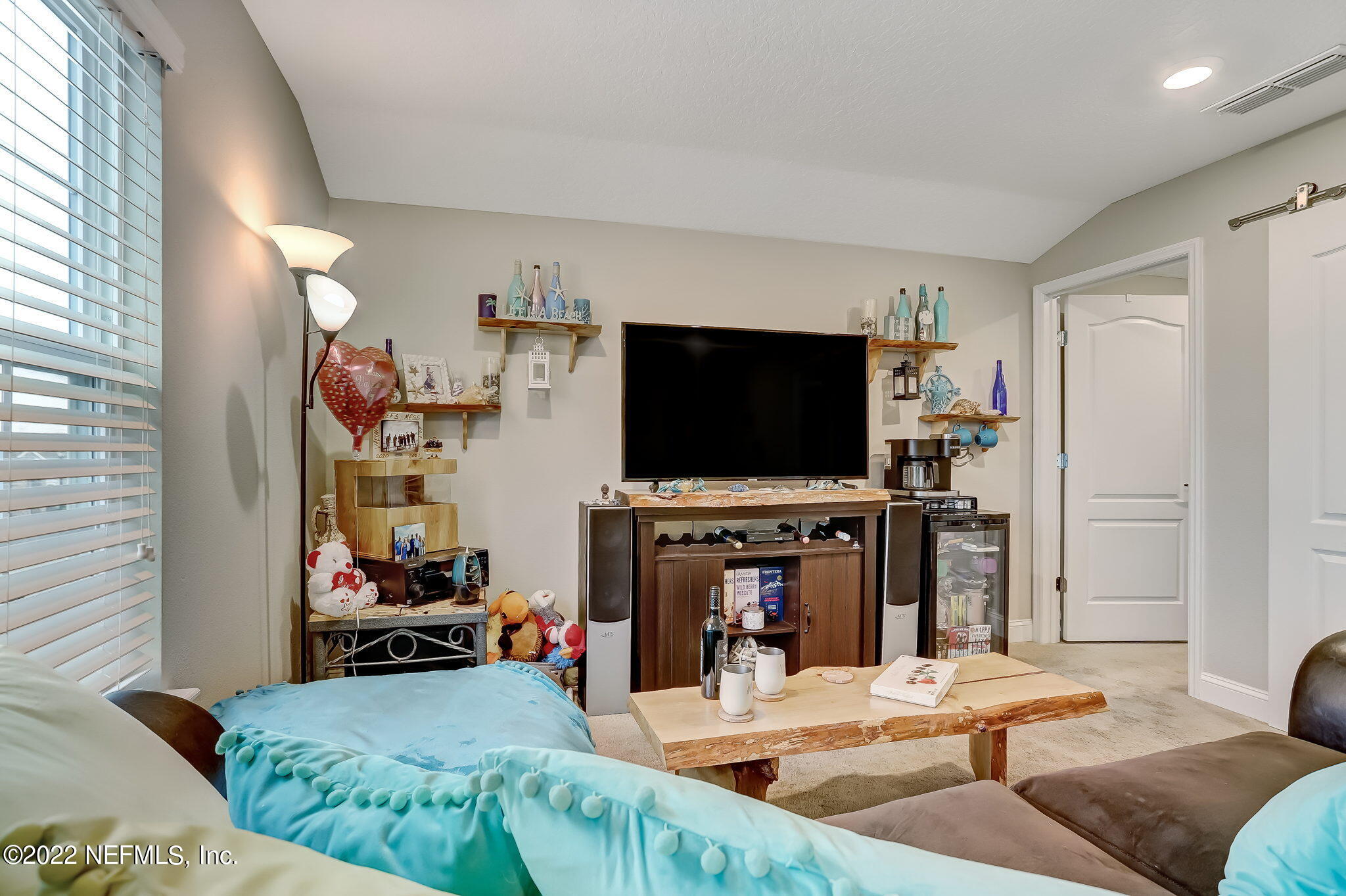 2564 Alexia Circle Jacksonville, FL 32246 - Photo 47 of 67 a living room with furniture and a flat screen tv