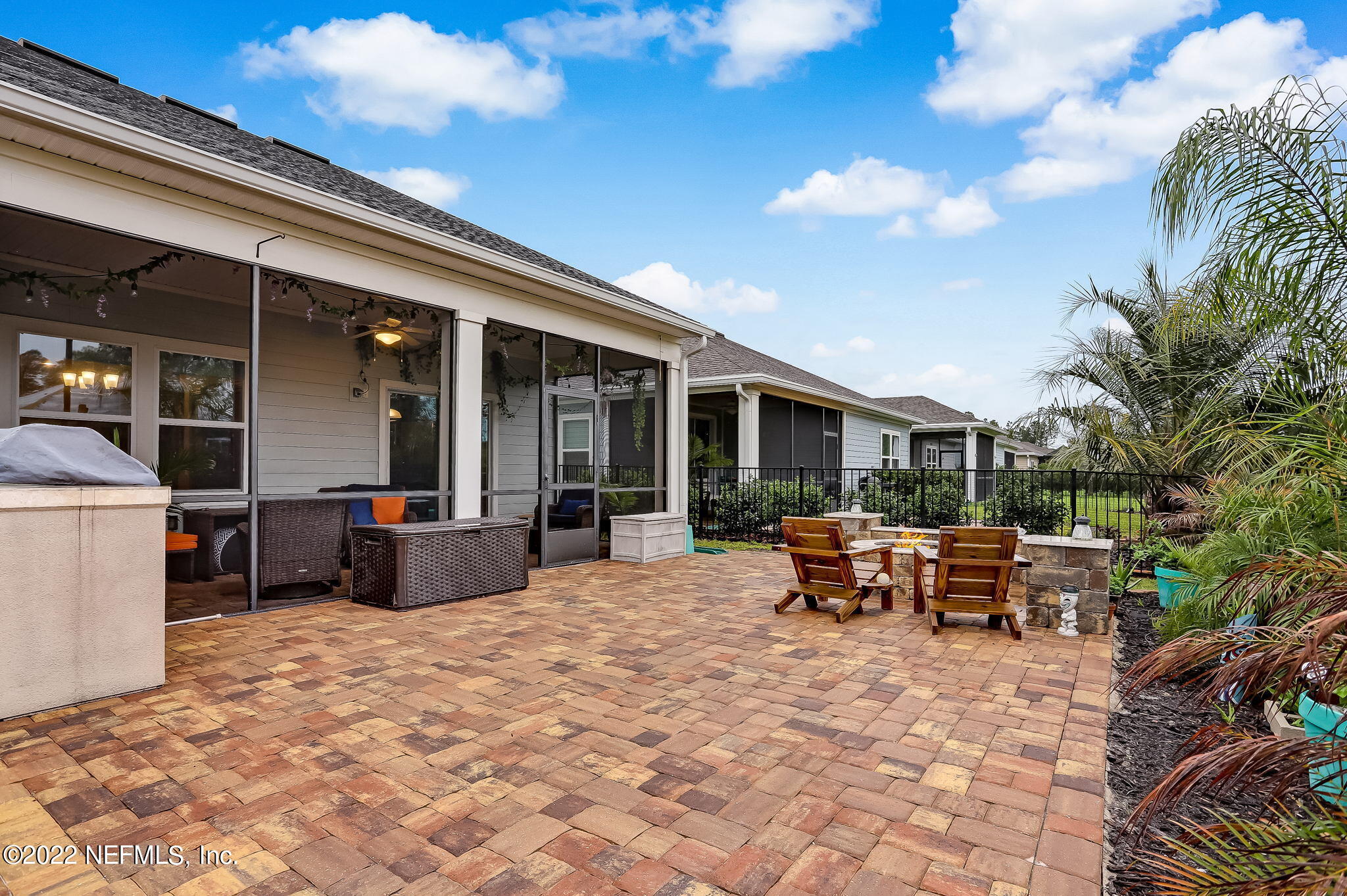 2564 Alexia Circle Jacksonville, FL 32246 - Photo 62 of 67 a view of a patio with dining table and chairs with wooden fence