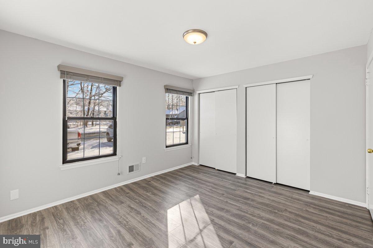 9 Devon Court Robbinsville, NJ 08691 - Photo 11 of 22 an empty room with wooden floor and windows
