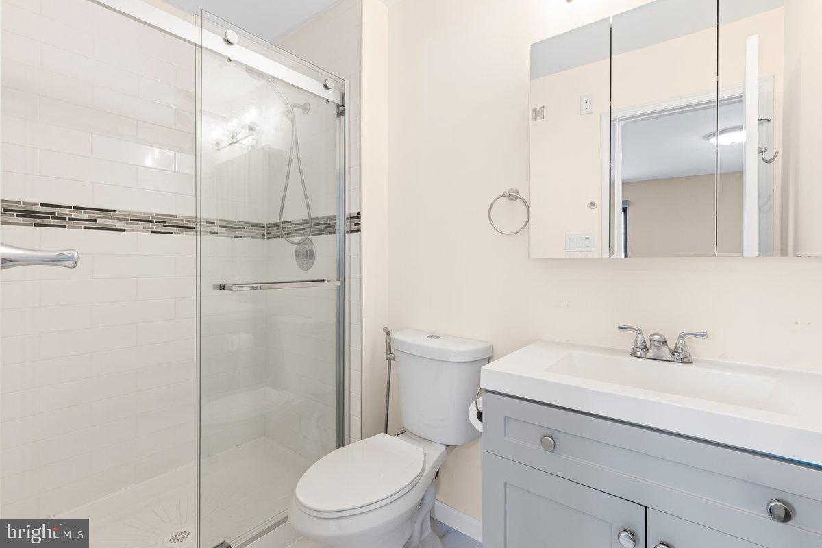 9 Devon Court Robbinsville, NJ 08691 - Photo 15 of 22 a bathroom with a toilet sink vanity and shower