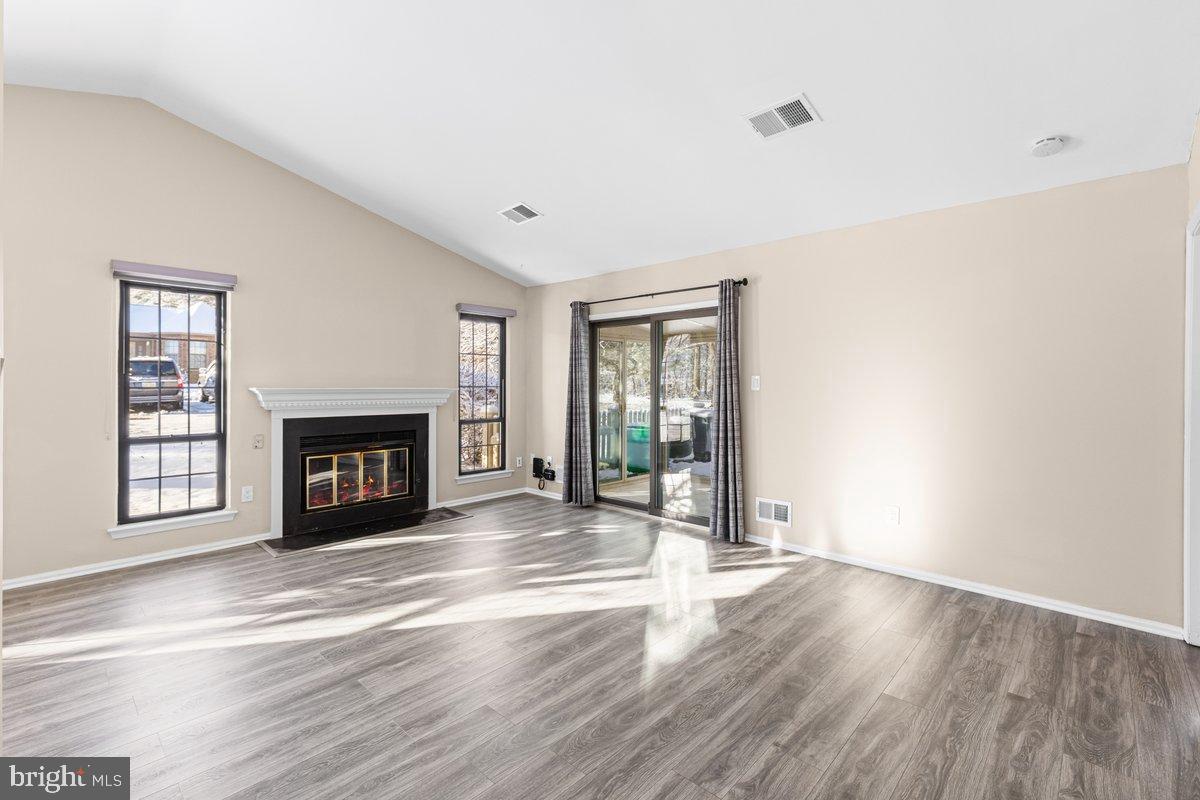 9 Devon Court Robbinsville, NJ 08691 - Photo 2 of 22 a view of an empty room with wooden floor and a window