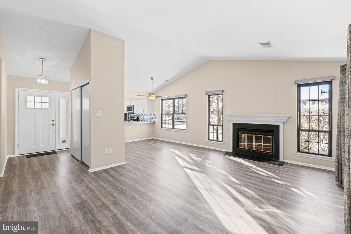 9 Devon Court Robbinsville, NJ 08691 - Photo 4 of 22 a view of a livingroom with wooden floor and a fireplace