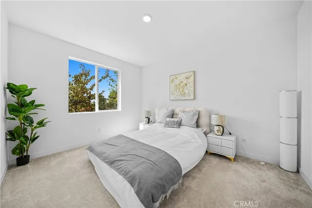 a bedroom with a bed and a painting on the wall