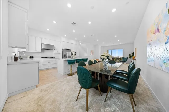 a living room with stainless steel appliances kitchen island granite countertop furniture and a kitchen view