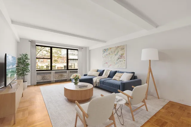 a living room with furniture a flat screen tv and a large window