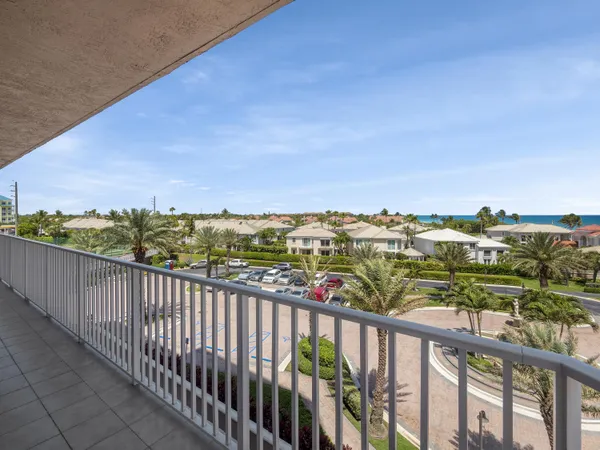 a view of a balcony with couches and wooden floor