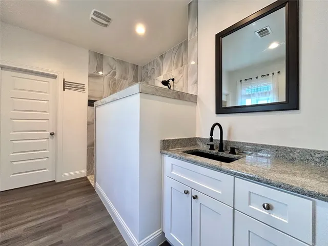 a bathroom with 2 sink toilet and a mirror