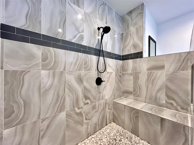 a bathroom with a granite countertop double vanity sink and mirror