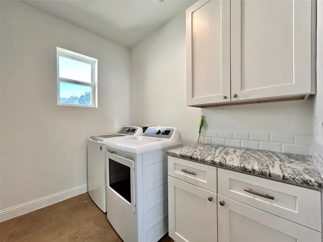 a bathroom with a granite countertop toilet a sink and bathtub