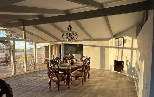 a view of a dining room with furniture large windows and wooden floor