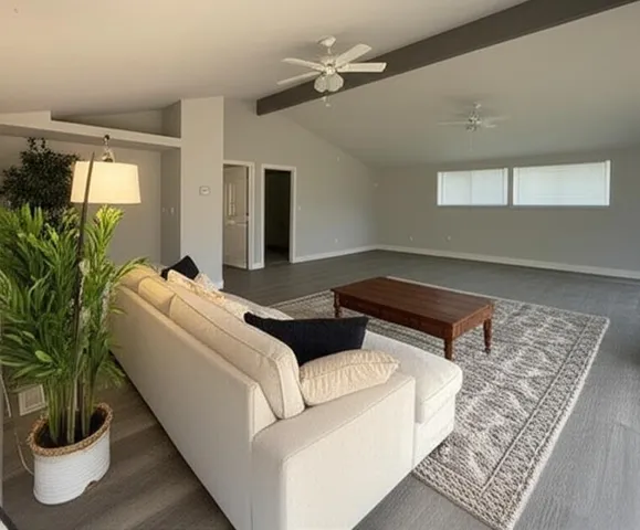 a living room with furniture and a potted plant