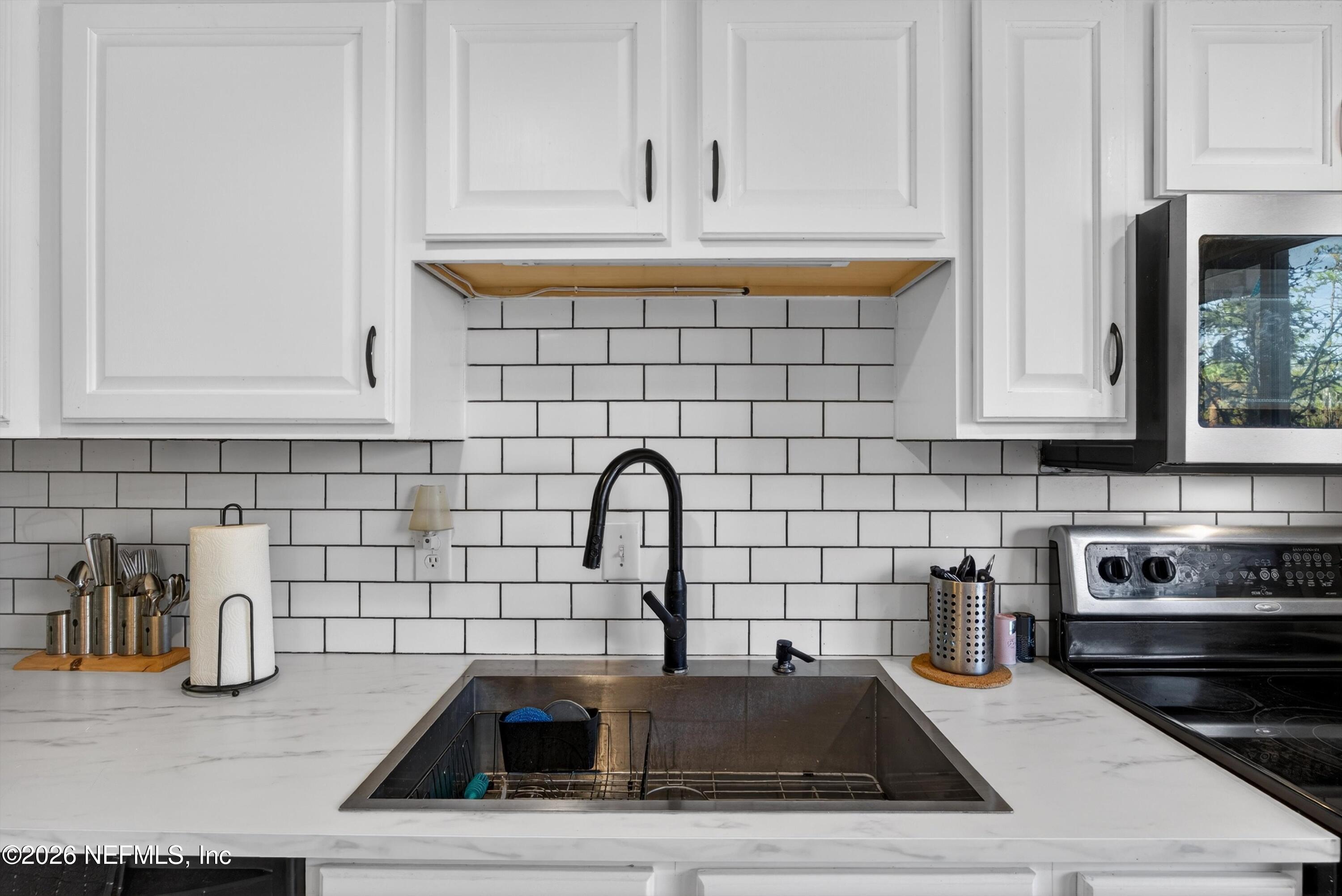 8880 Old Kings Road South, Unit 2 Jacksonville, FL 32257 - Photo 11 of 35 a kitchen with a sink cabinets and appliances