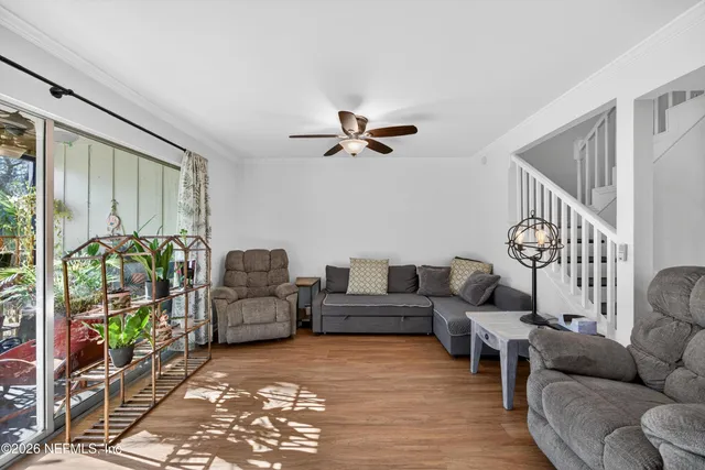 a living room with furniture and a floor to ceiling window