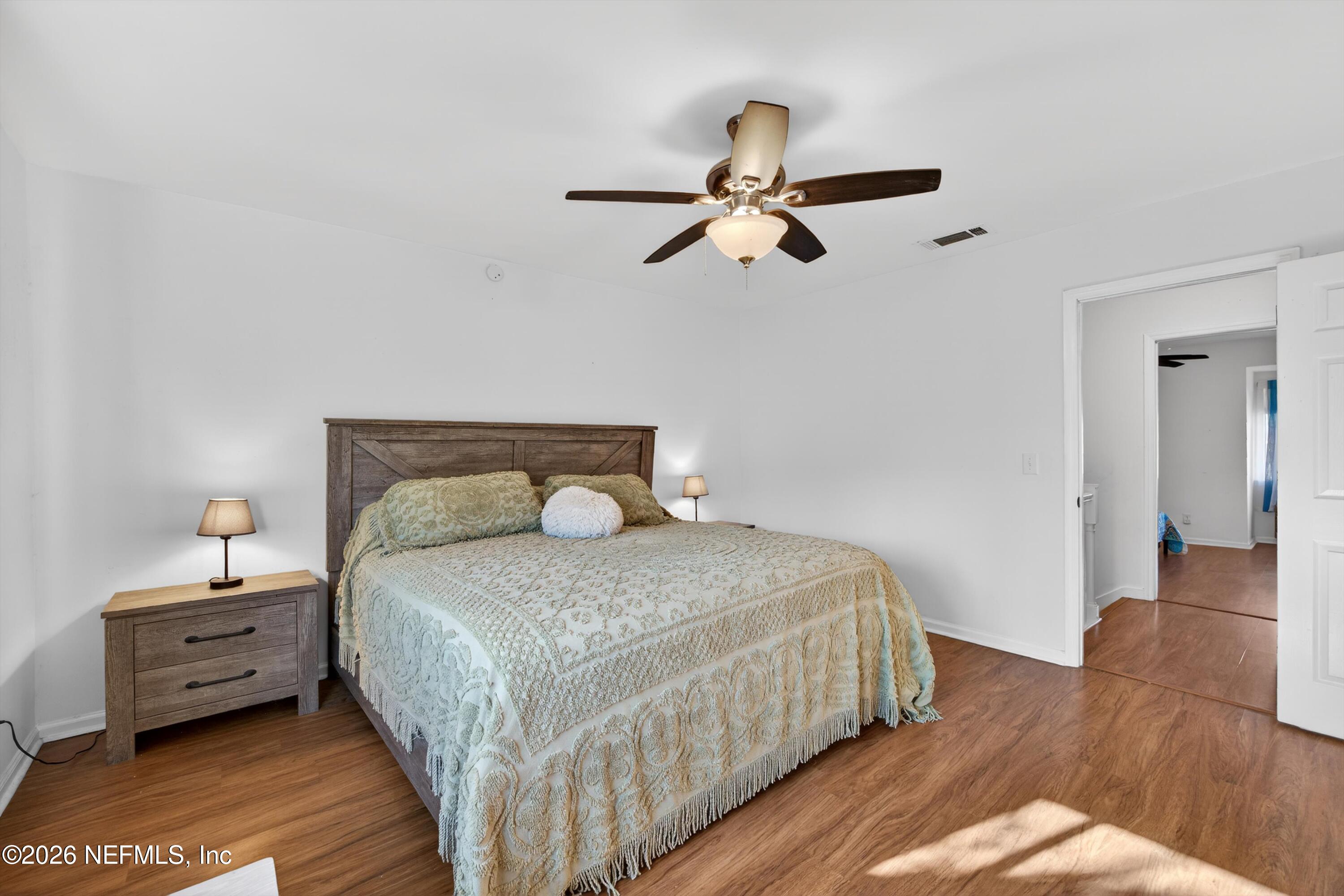 8880 Old Kings Road South, Unit 2 Jacksonville, FL 32257 - Photo 20 of 35 a bedroom with a bed and wooden floor