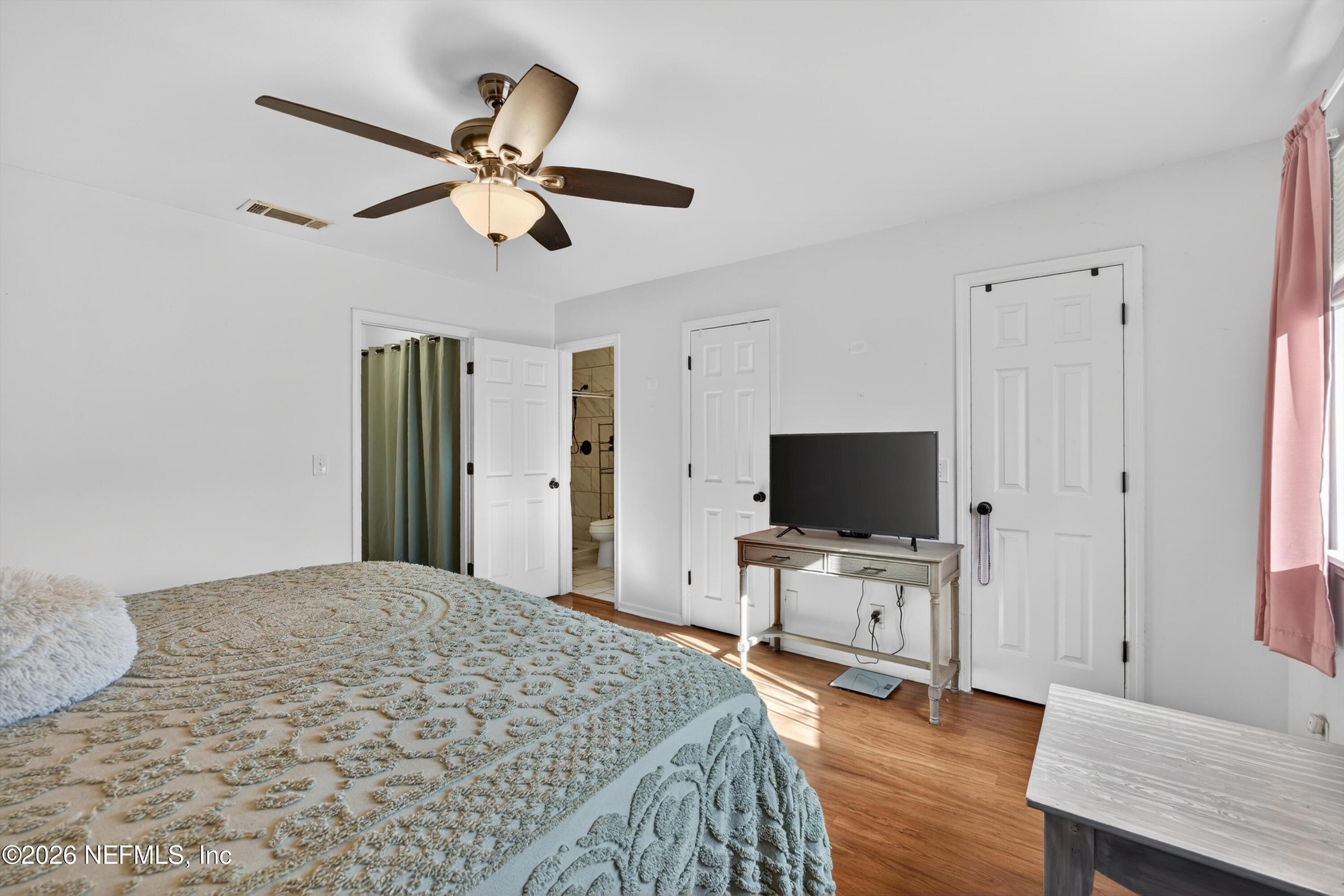 8880 Old Kings Road South, Unit 2 Jacksonville, FL 32257 - Photo 21 of 35 a bedroom with a bed and a flat screen tv