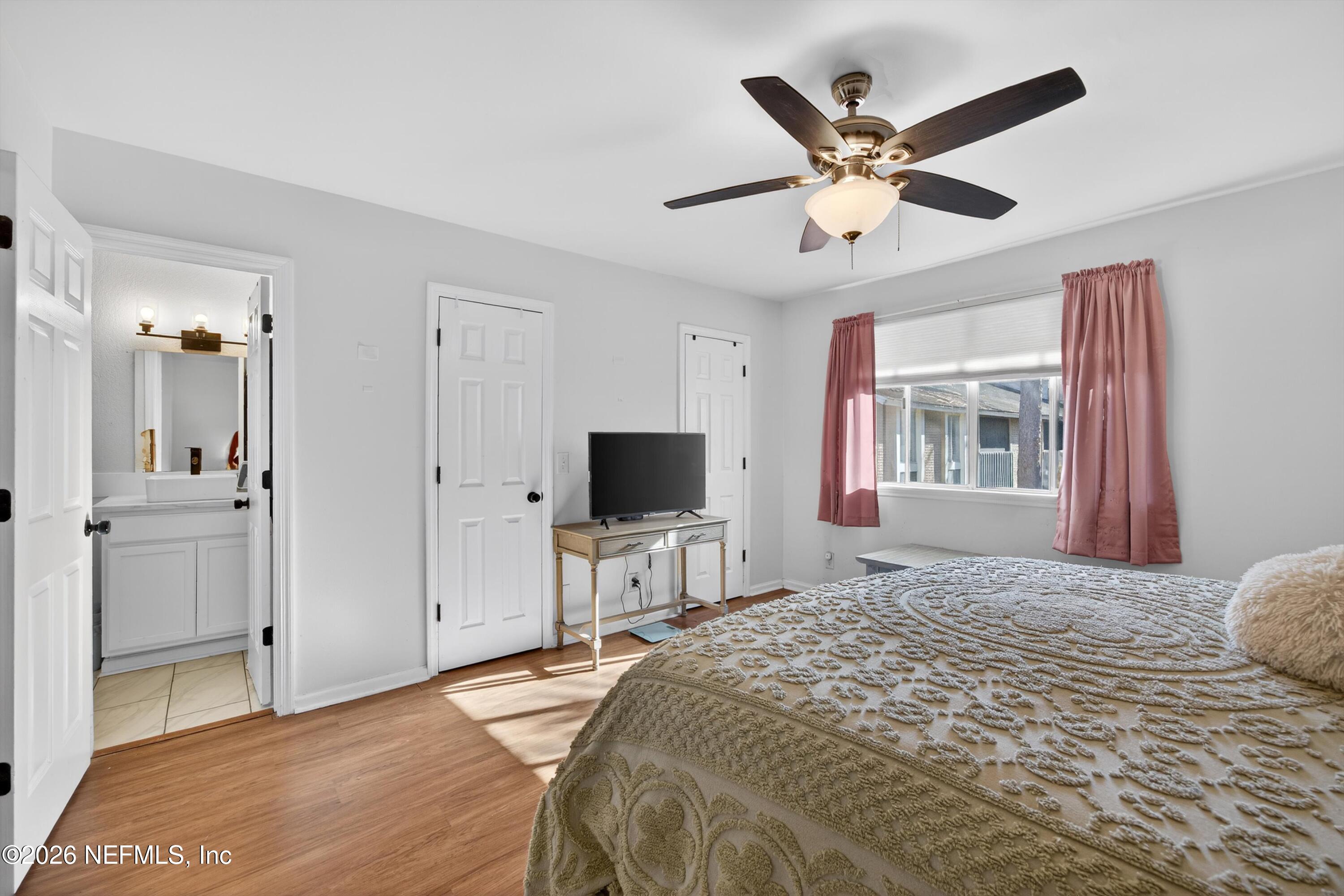 8880 Old Kings Road South, Unit 2 Jacksonville, FL 32257 - Photo 22 of 35 a bedroom with a bed and a large mirror on the dresser