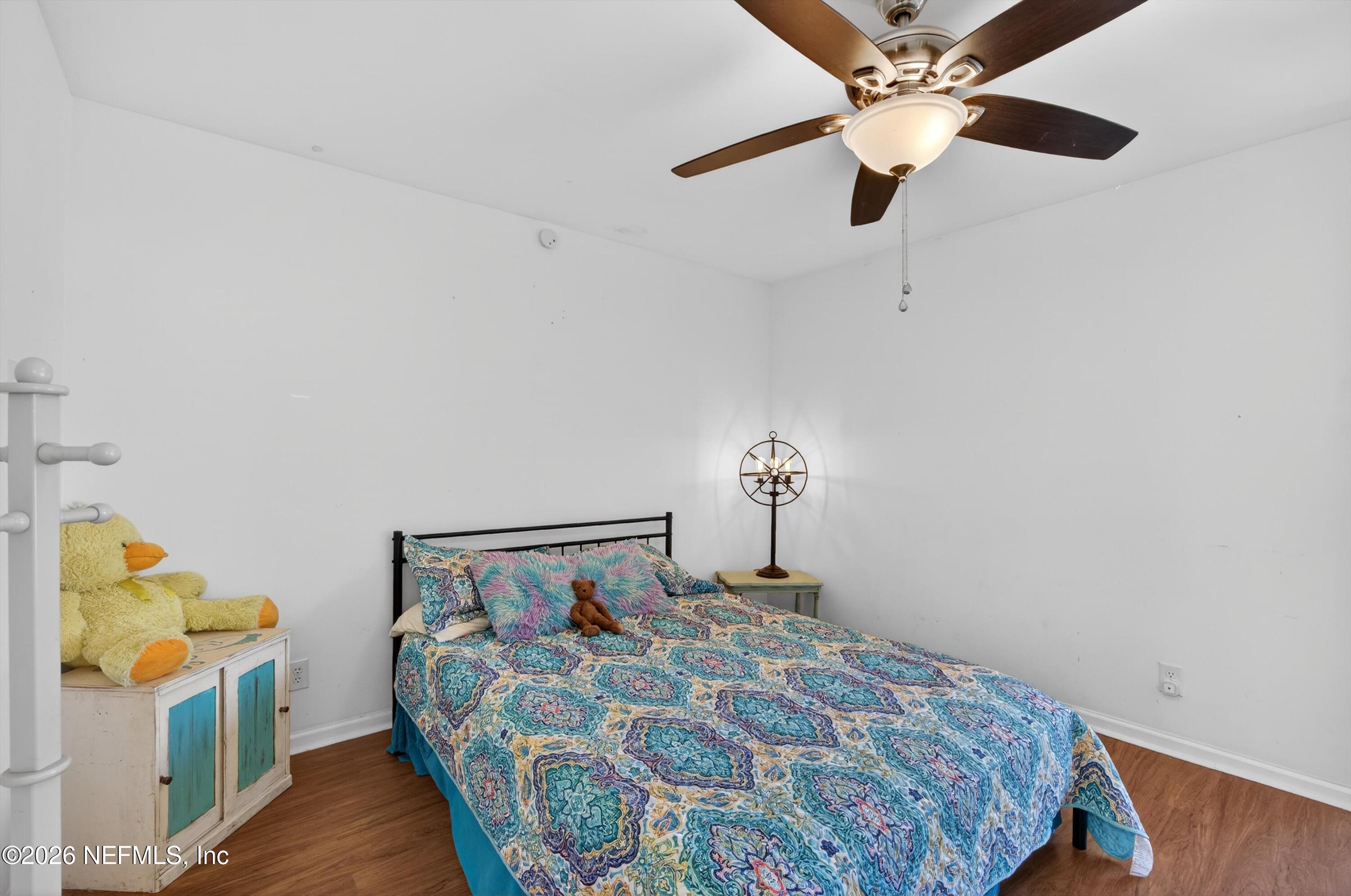 8880 Old Kings Road South, Unit 2 Jacksonville, FL 32257 - Photo 24 of 35 a bedroom with a bed and a chandelier