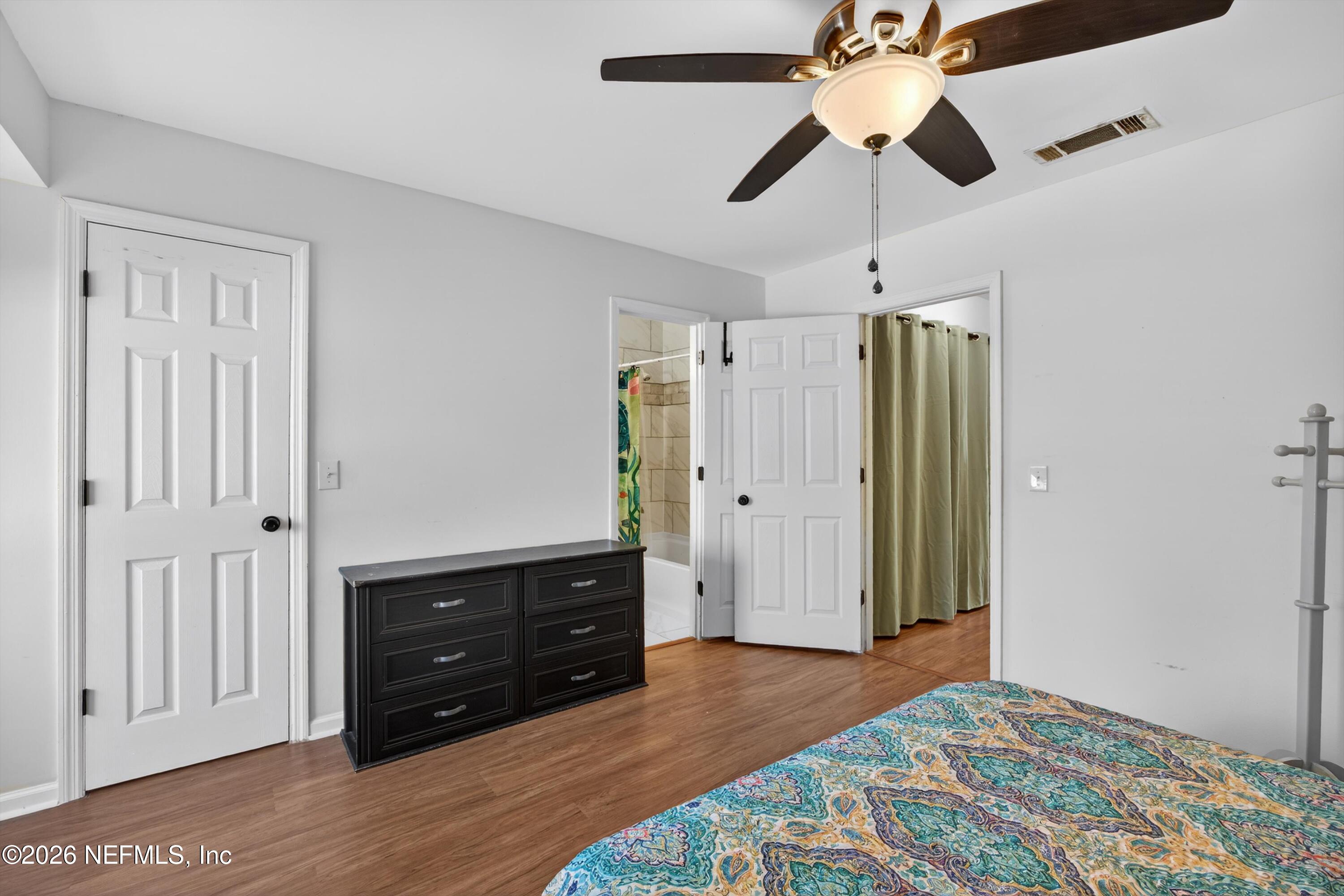 8880 Old Kings Road South, Unit 2 Jacksonville, FL 32257 - Photo 26 of 35 a bedroom with a bed and a ceiling fan