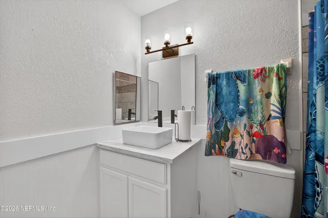 a bathroom with a sink vanity and a mirror