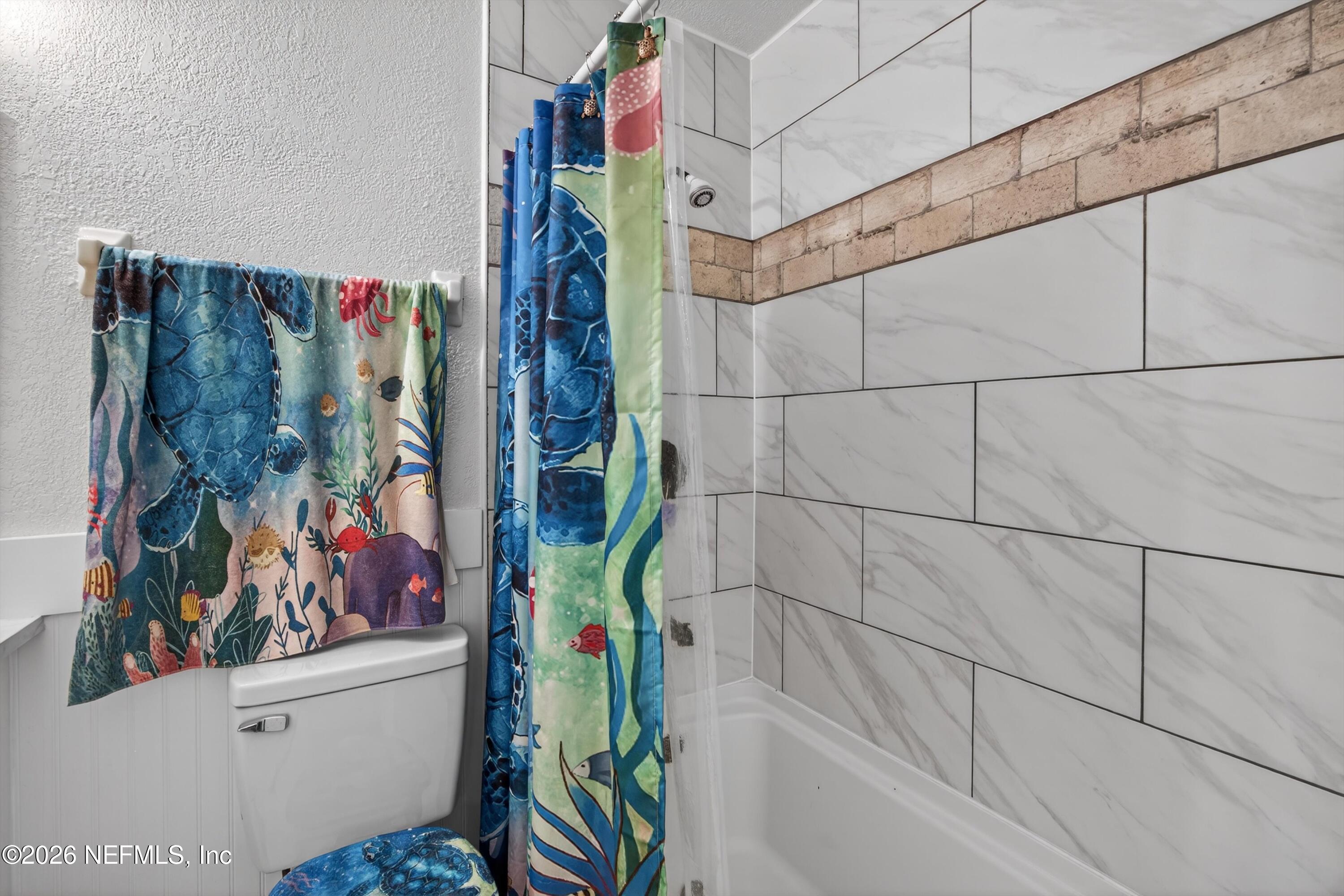 8880 Old Kings Road South, Unit 2 Jacksonville, FL 32257 - Photo 28 of 35 a bathroom with a bathtub and toilet