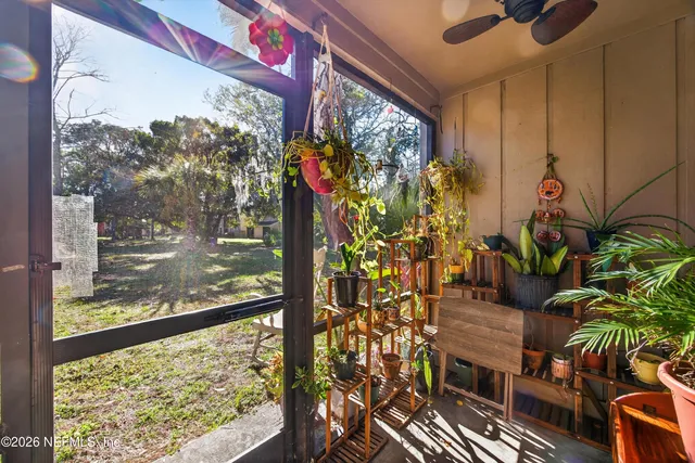 a vase of flowers sitting on a table in front of a window