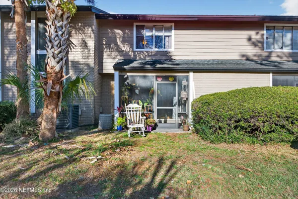 a view of a house with backyard and sitting area