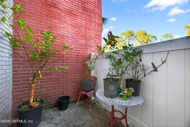 a vase of flowers sitting on a floor