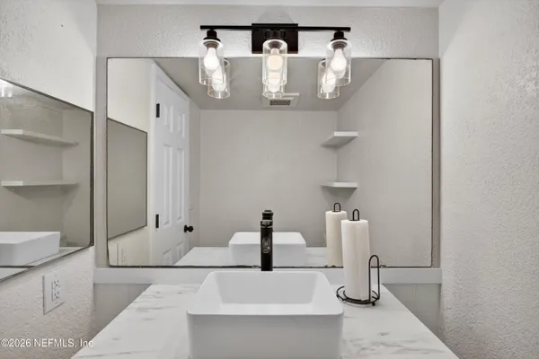 a bathroom with a sink and mirror