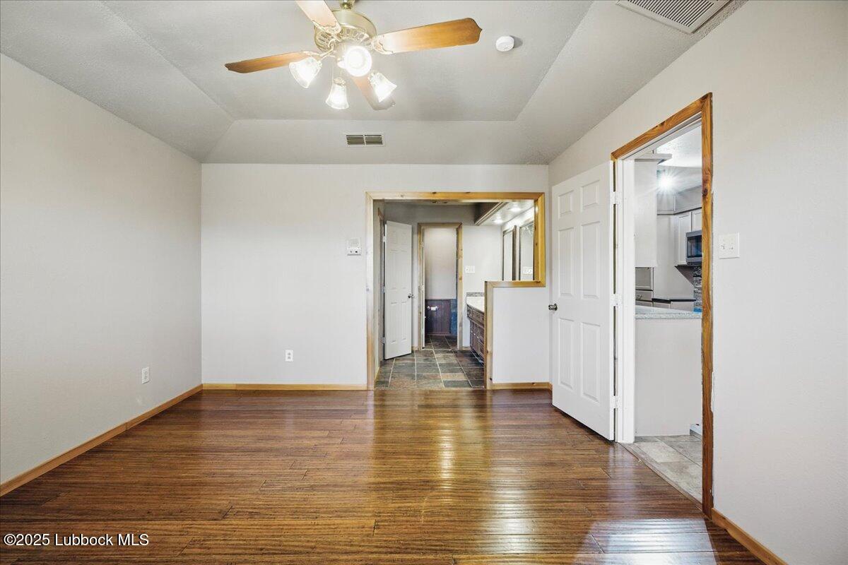 5726 67th Street Lubbock, TX 79424 - Photo 14 of 26 a view of a hallway with wooden floor
