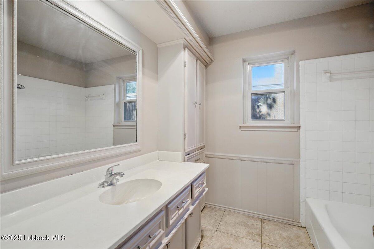 5726 67th Street Lubbock, TX 79424 - Photo 18 of 26 a bathroom with a sink and a mirror