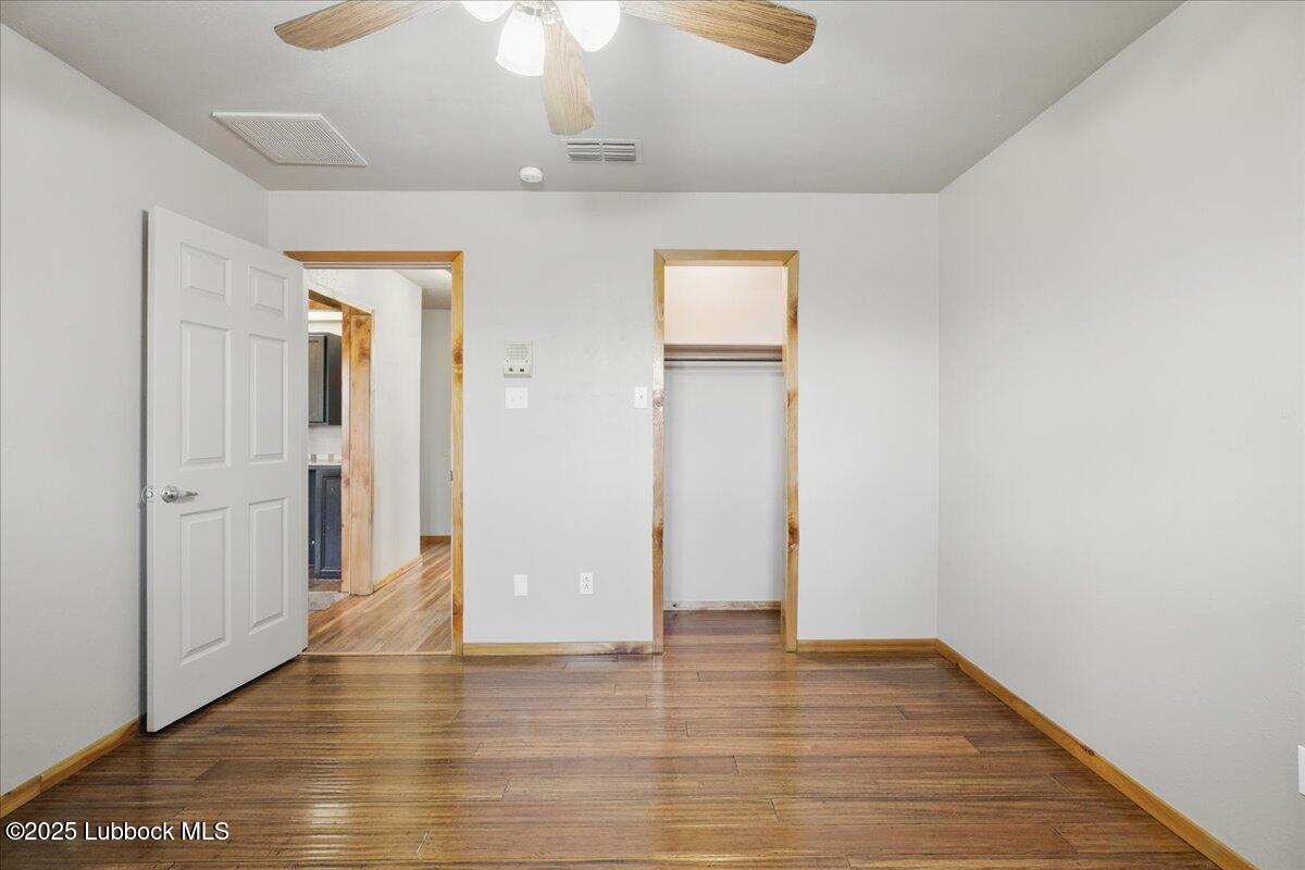 5726 67th Street Lubbock, TX 79424 - Photo 19 of 26 wooden floor in an empty room with a window