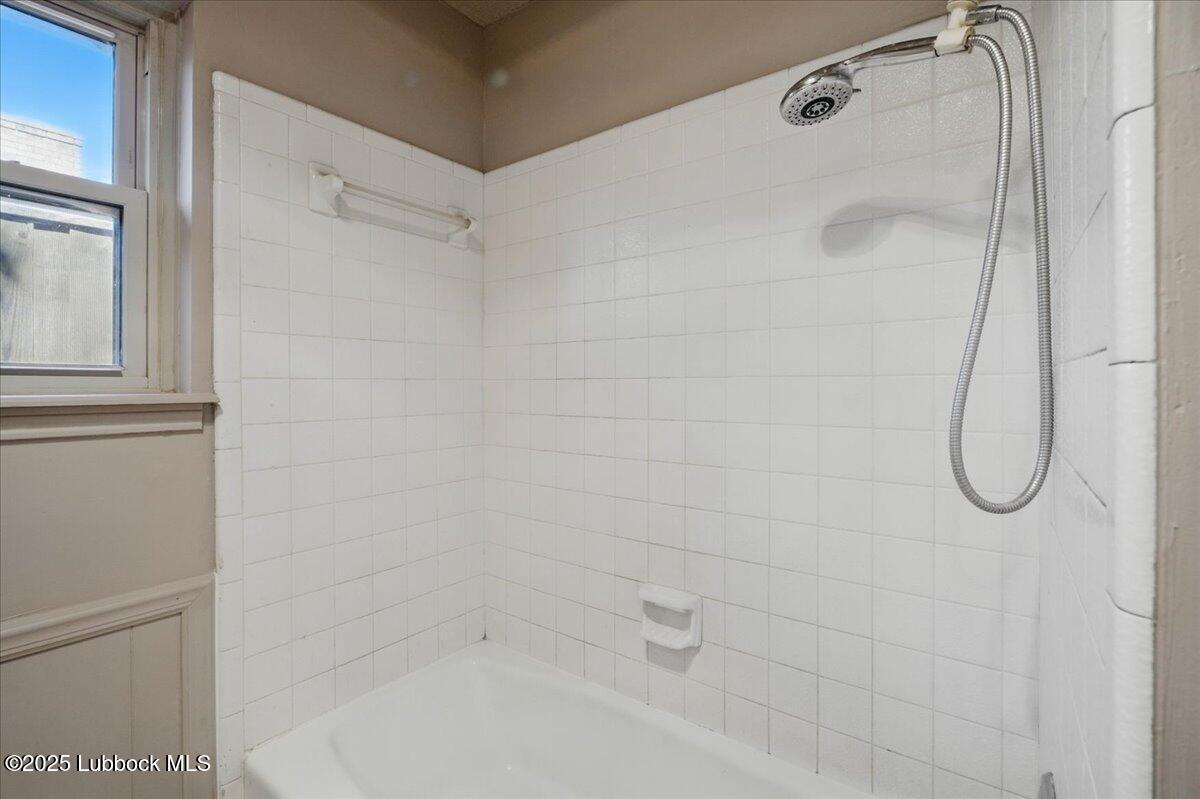 5726 67th Street Lubbock, TX 79424 - Photo 20 of 26 a bathroom with a bath tub with a shower