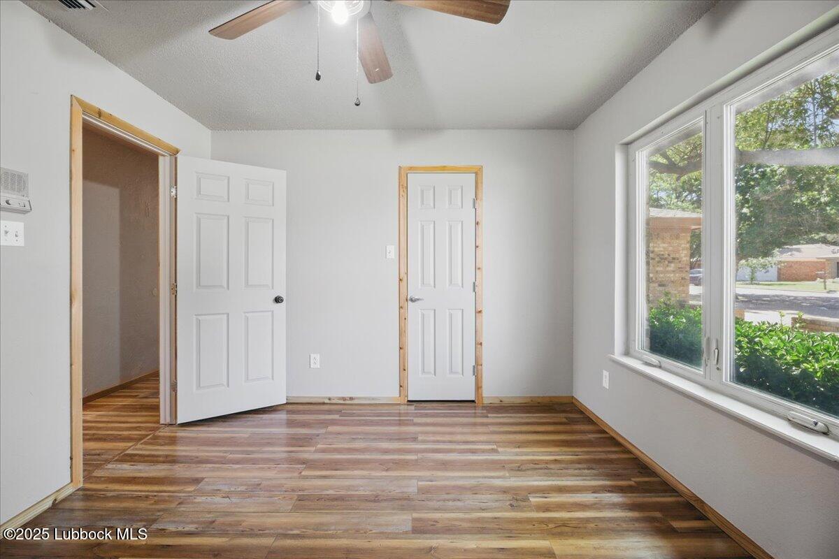 5726 67th Street Lubbock, TX 79424 - Photo 22 of 26 a view of a livingroom with wooden floor and window