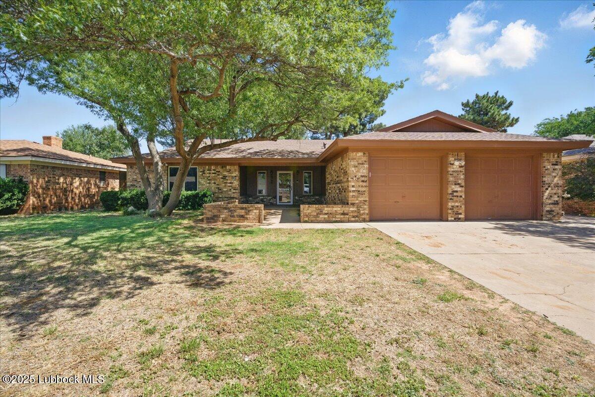 5726 67th Street Lubbock, TX 79424 - Photo 26 of 26 a front view of a house with garden