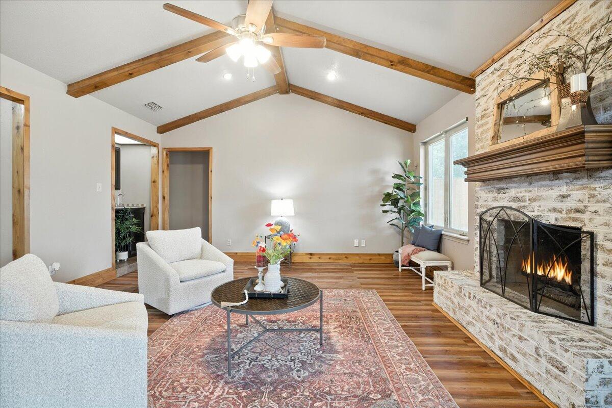 5726 67th Street Lubbock, TX 79424 - Photo 5 of 26 a living room with furniture and a fireplace