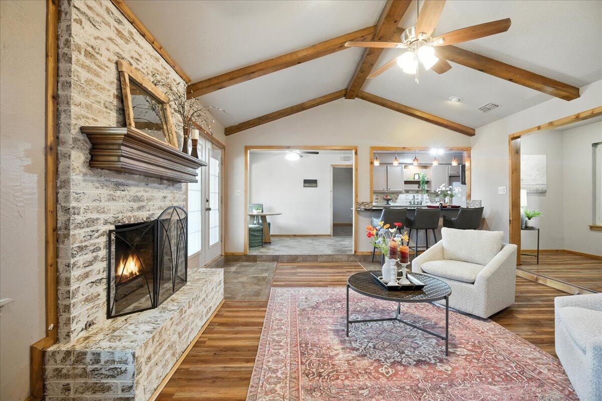 5726 67th Street Lubbock, TX 79424 - Photo 7 of 26 a living room with furniture and a fireplace