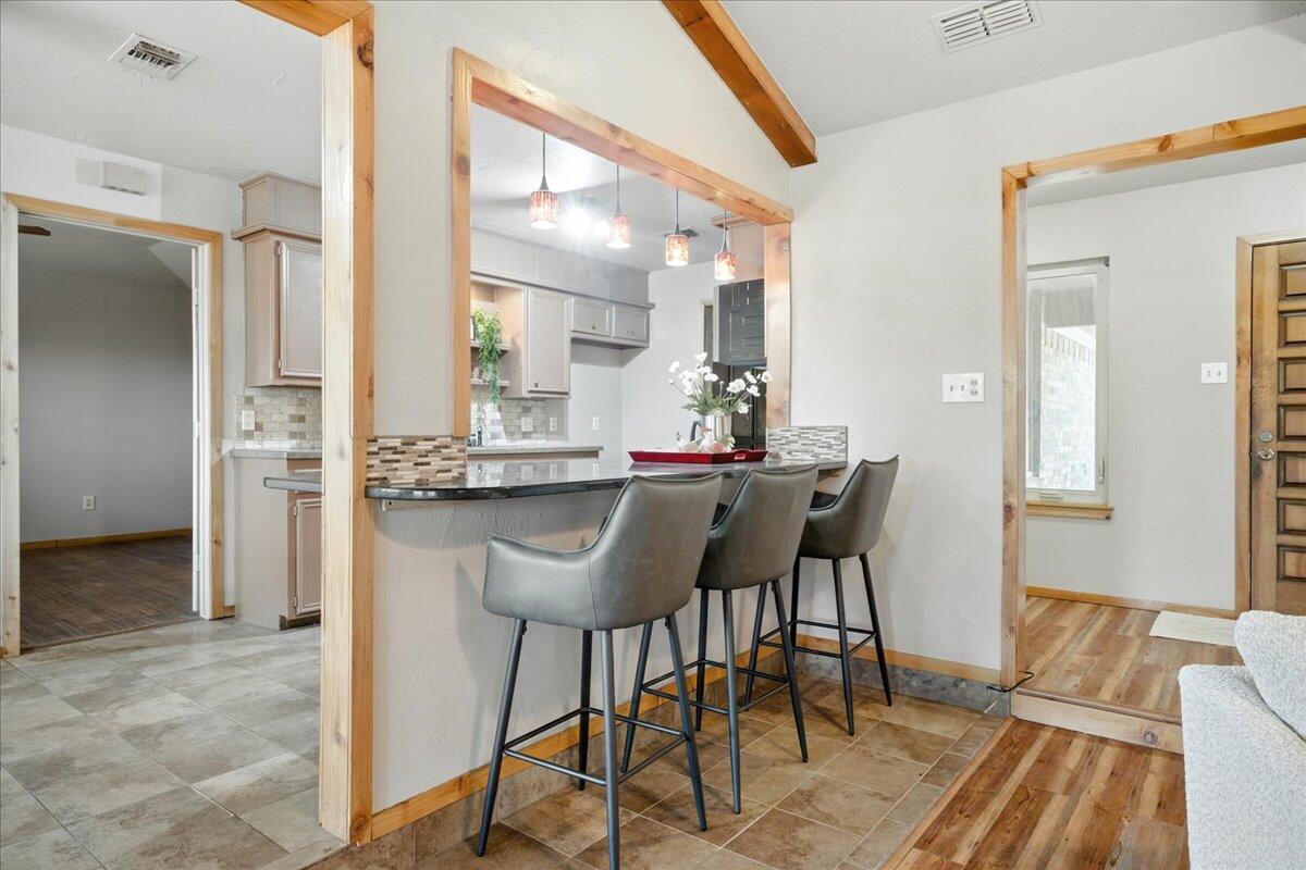 5726 67th Street Lubbock, TX 79424 - Photo 8 of 26 a view of a dining room with furniture and wooden floor