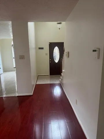 a view of a hallway with wooden floor