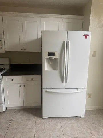 a white refrigerator freezer sitting in a kitchen